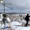 A view of the met station at Toolik while Steve Oberbauer works in the background